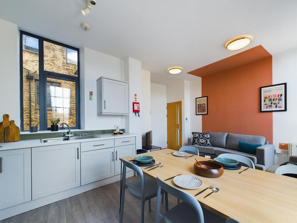 A modern and inviting kitchenette with ample na...