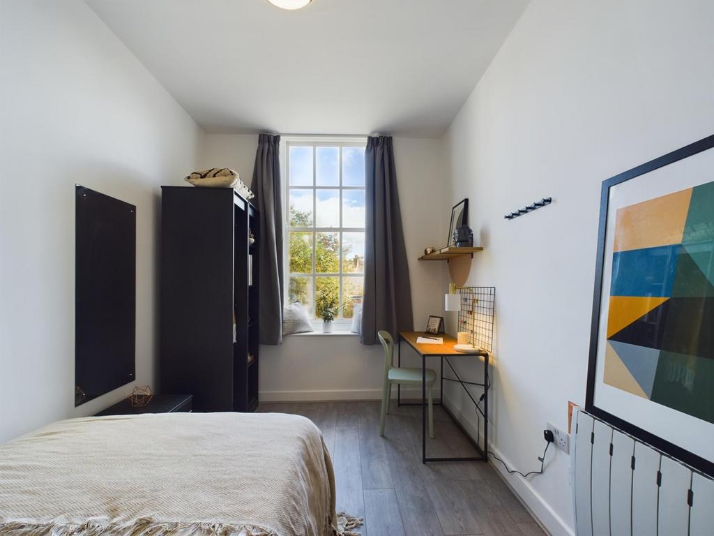 A bright and inviting double bedroom featuring ...