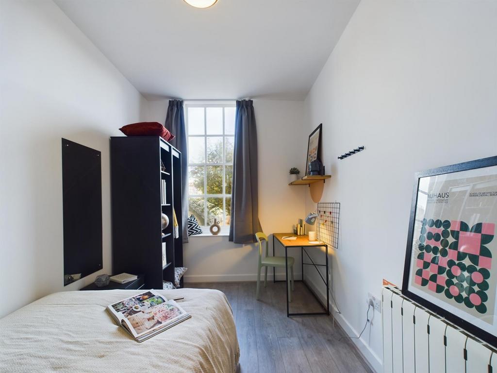 A bright and inviting double bedroom featuring ...