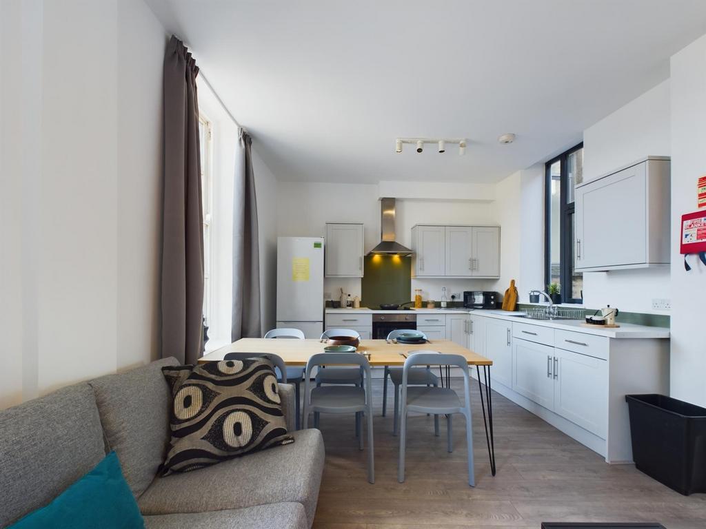 A bright and modern kitchen with ample space fo...
