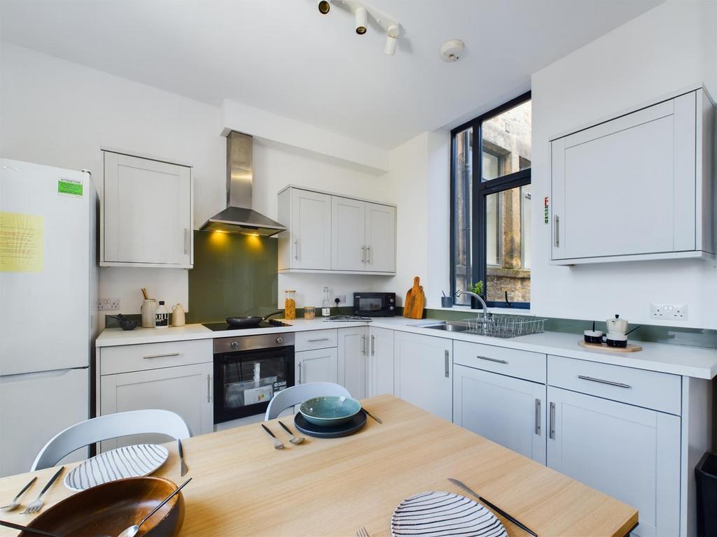 A bright and modern kitchen with ample space an...