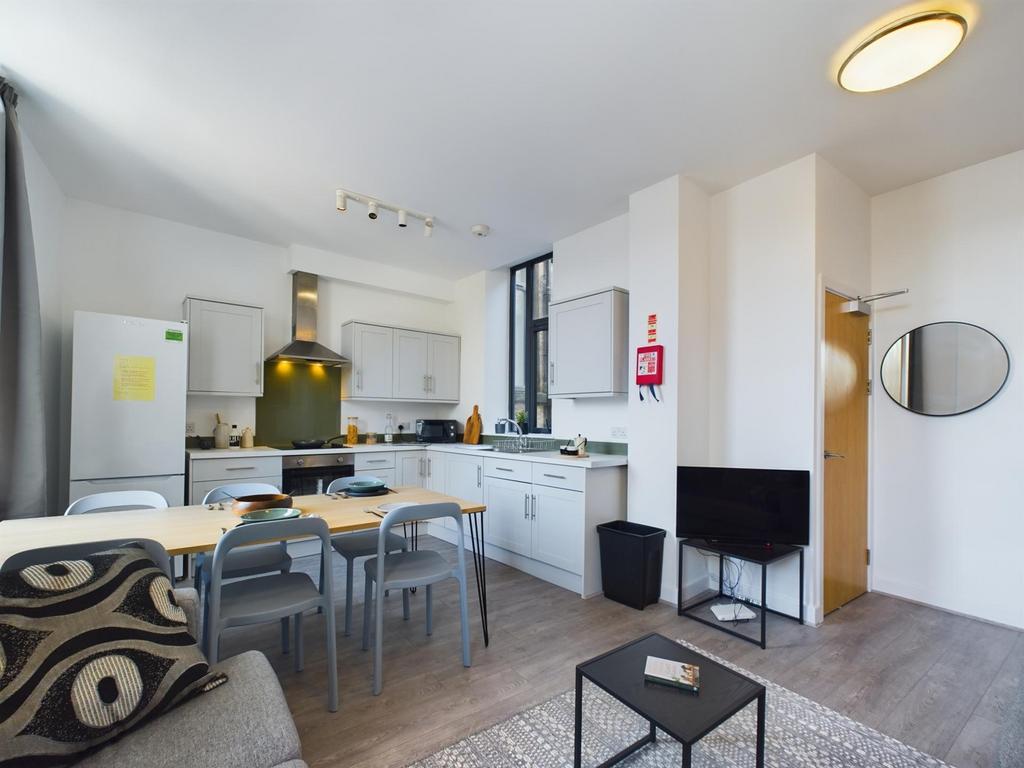 A modern and spacious kitchenette with ample na...