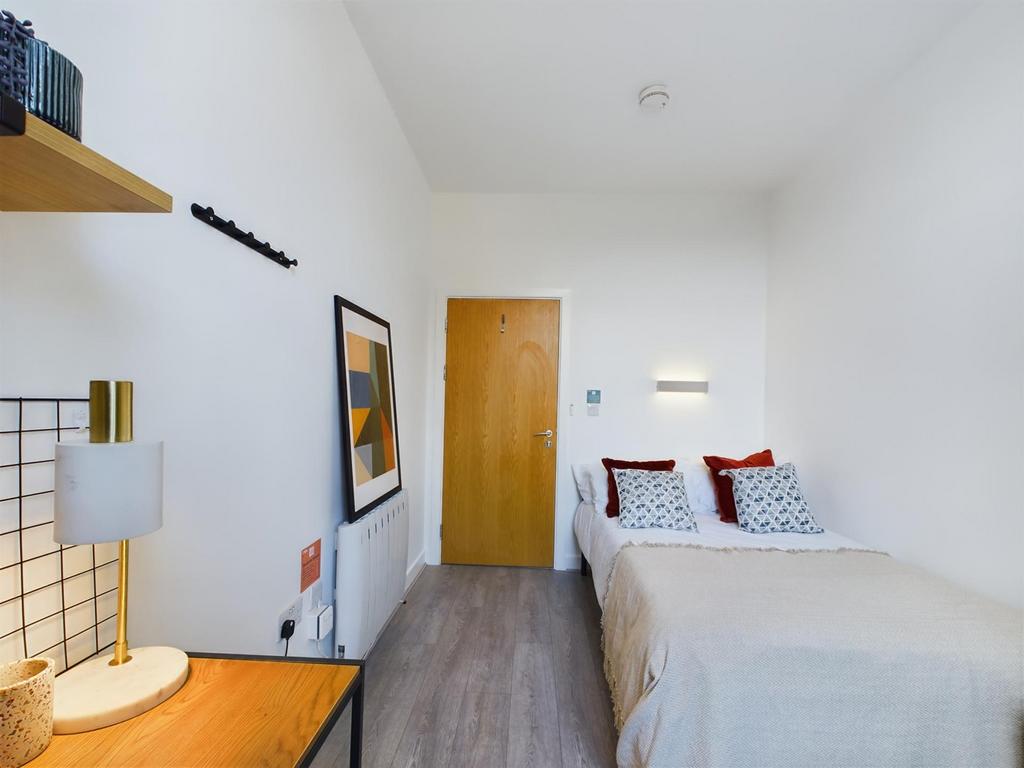 A clean and bright double bedroom with stylish ...