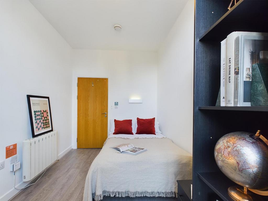 A bright and inviting double bedroom featuring ...