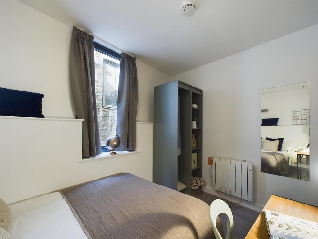A bright and inviting double bedroom with moder...