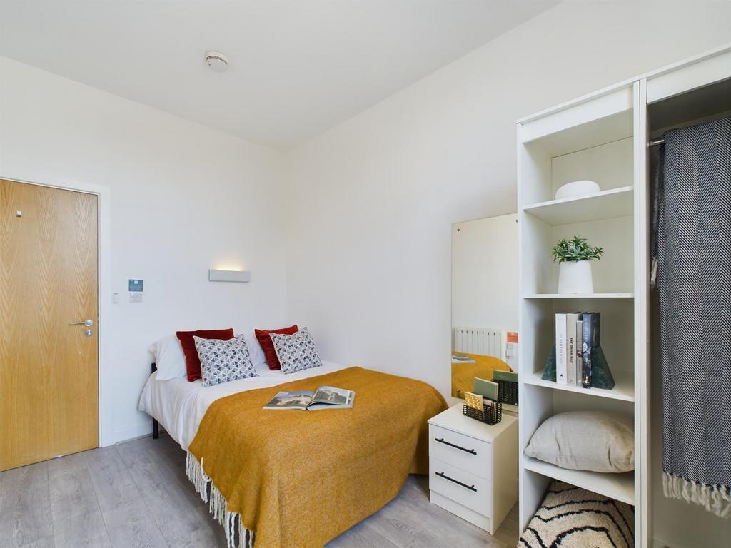 A bright and inviting double bedroom featuring ...