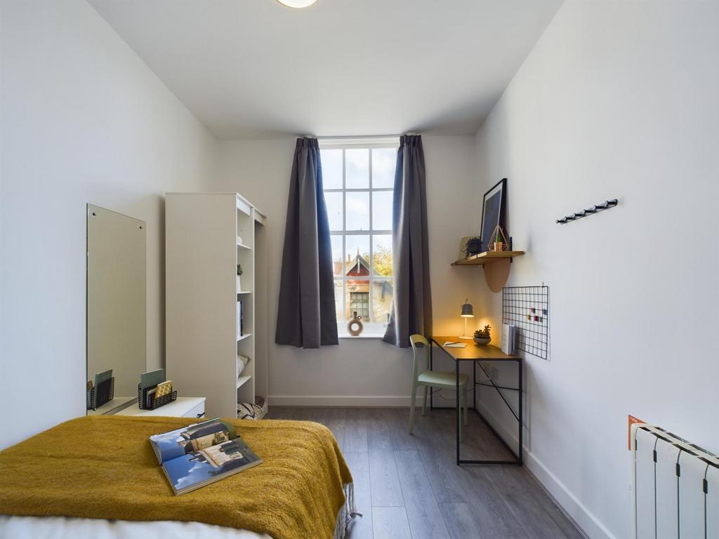 A bright and inviting double bedroom with ample...