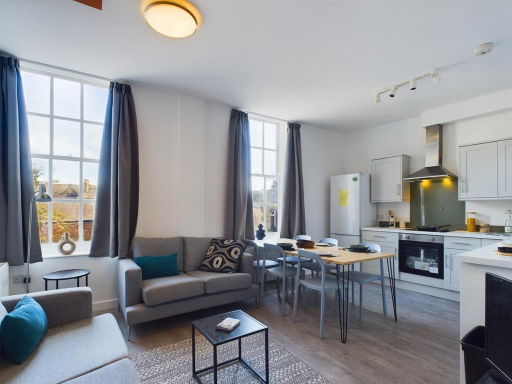 A bright and modern kitchenette with ample seat...