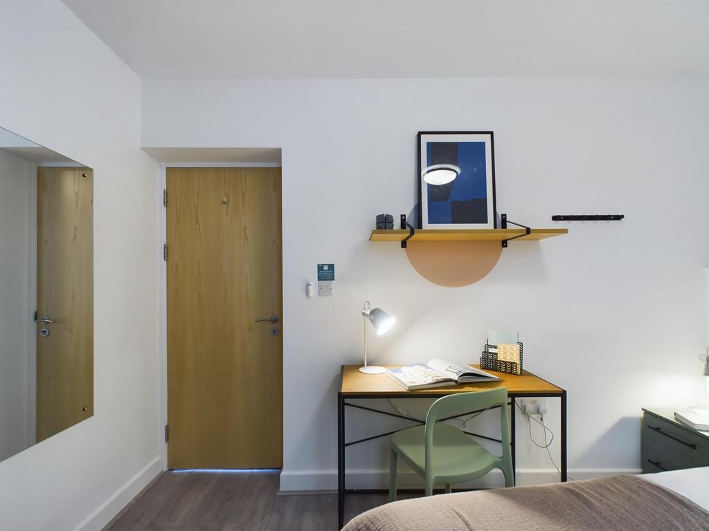 A bright and tidy double bedroom featuring a st...