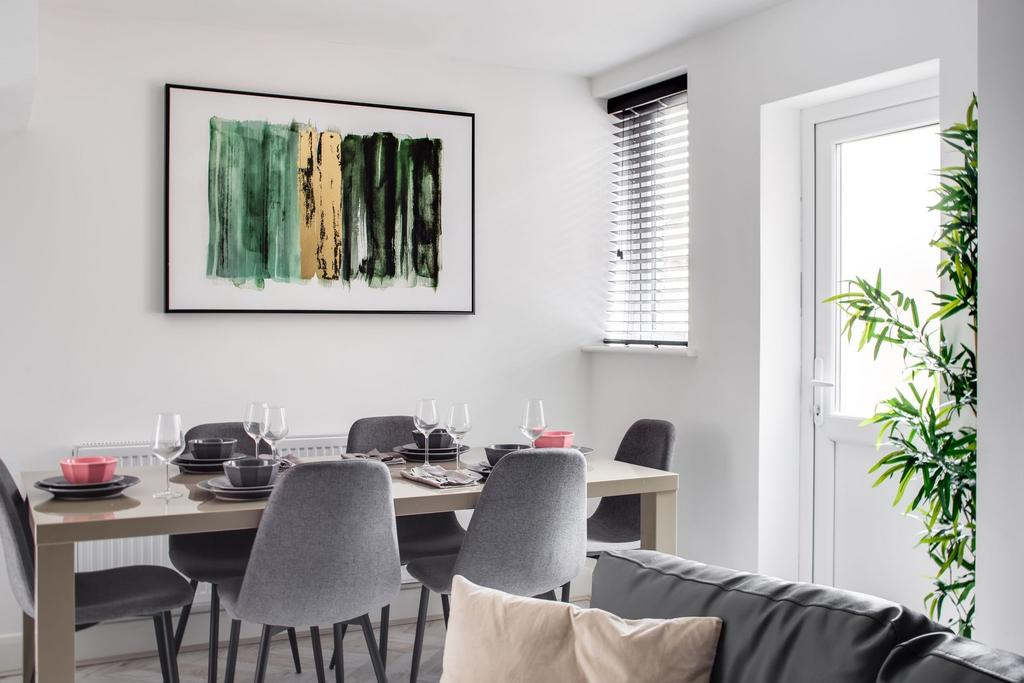 A bright and modern living room featuring a min...