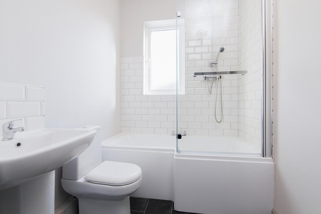 Modern bathroom featuring a stylish bathtub and...