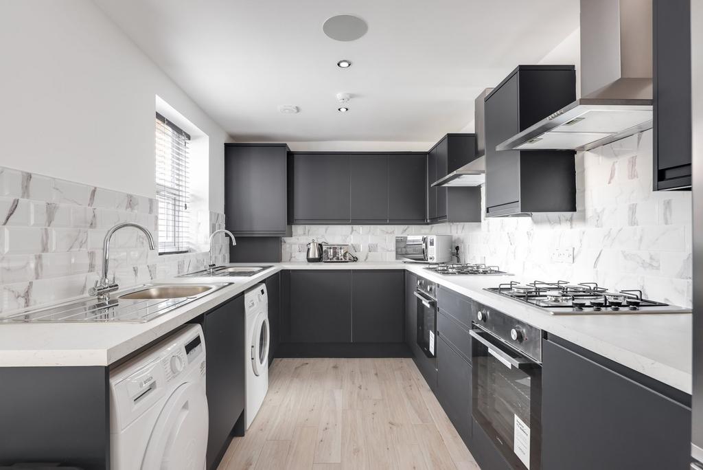 Modern and stylish kitchen with sleek black cab...