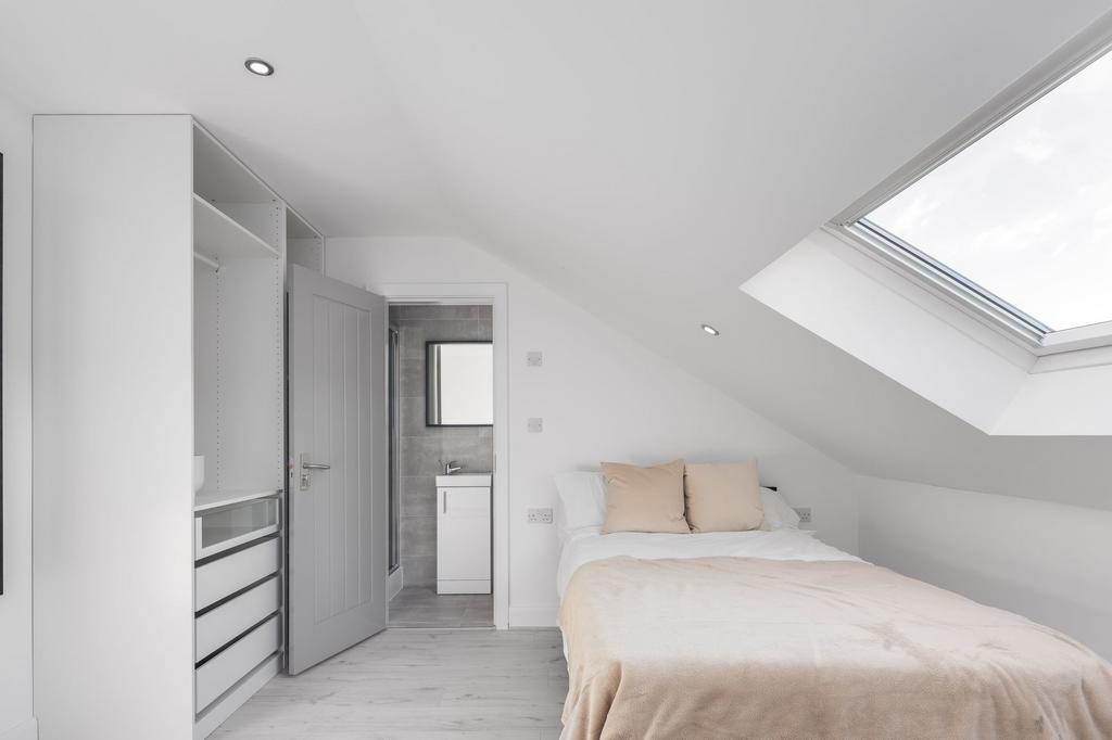 Bright and modern bedroom featuring a comfortab...