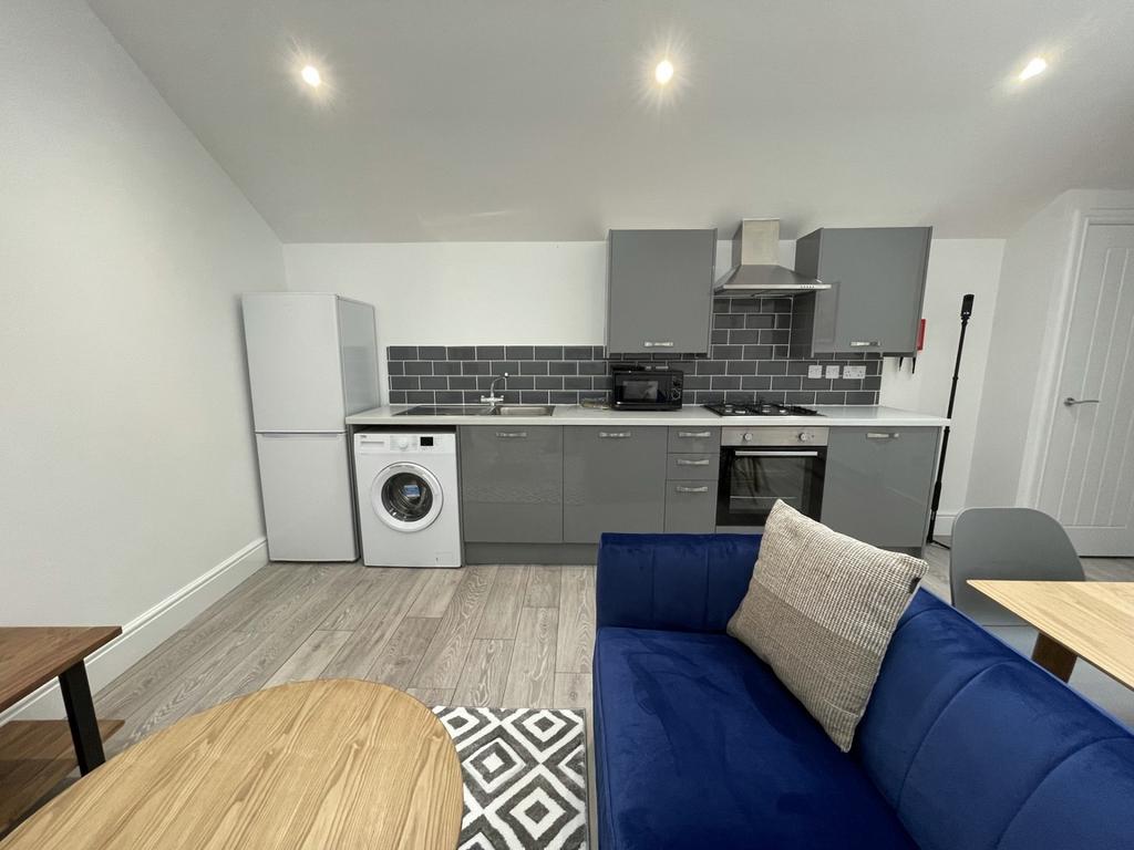 A modern kitchenette with sleek appliances and ...