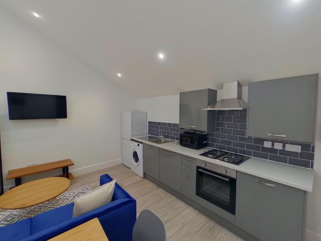 A modern and tidy kitchenette with stylish appl...