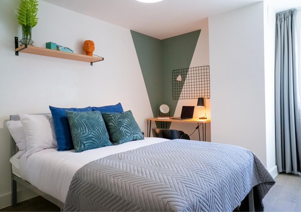 A modern and well-presented master bedroom feat...