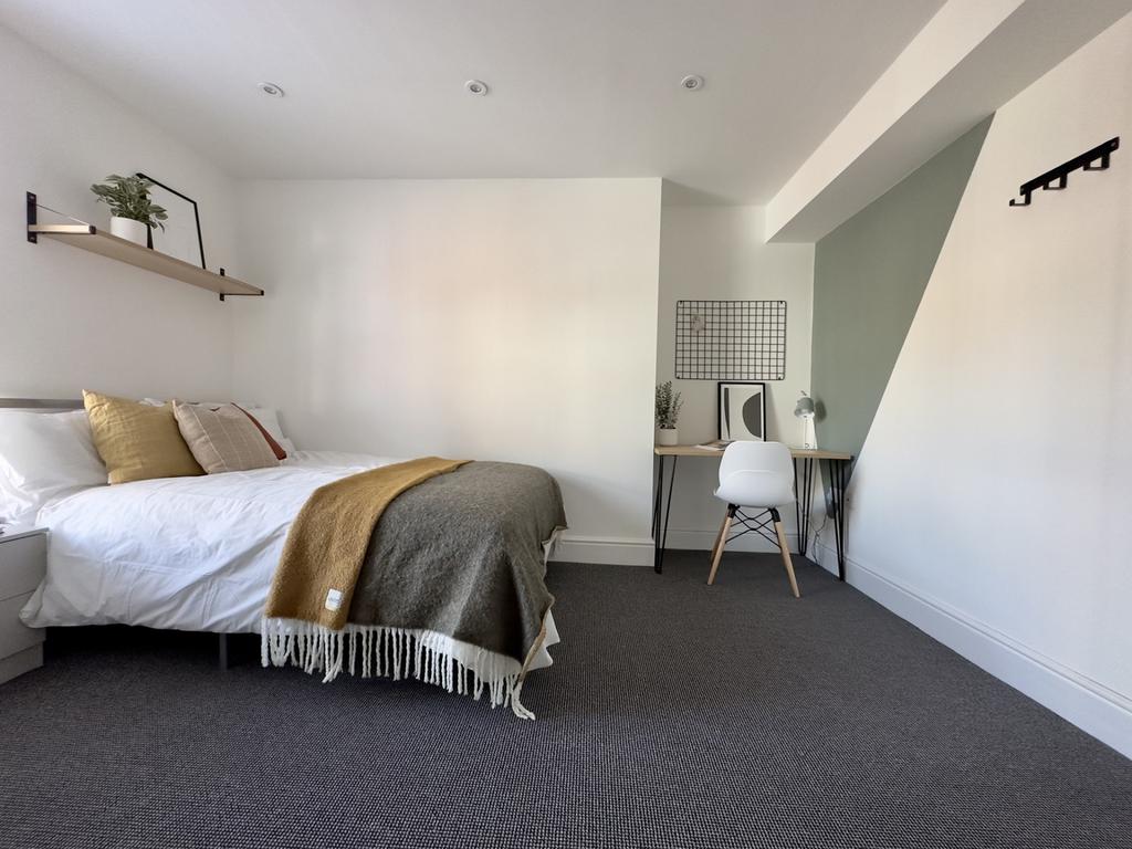 A bright and spacious double bedroom featuring ...