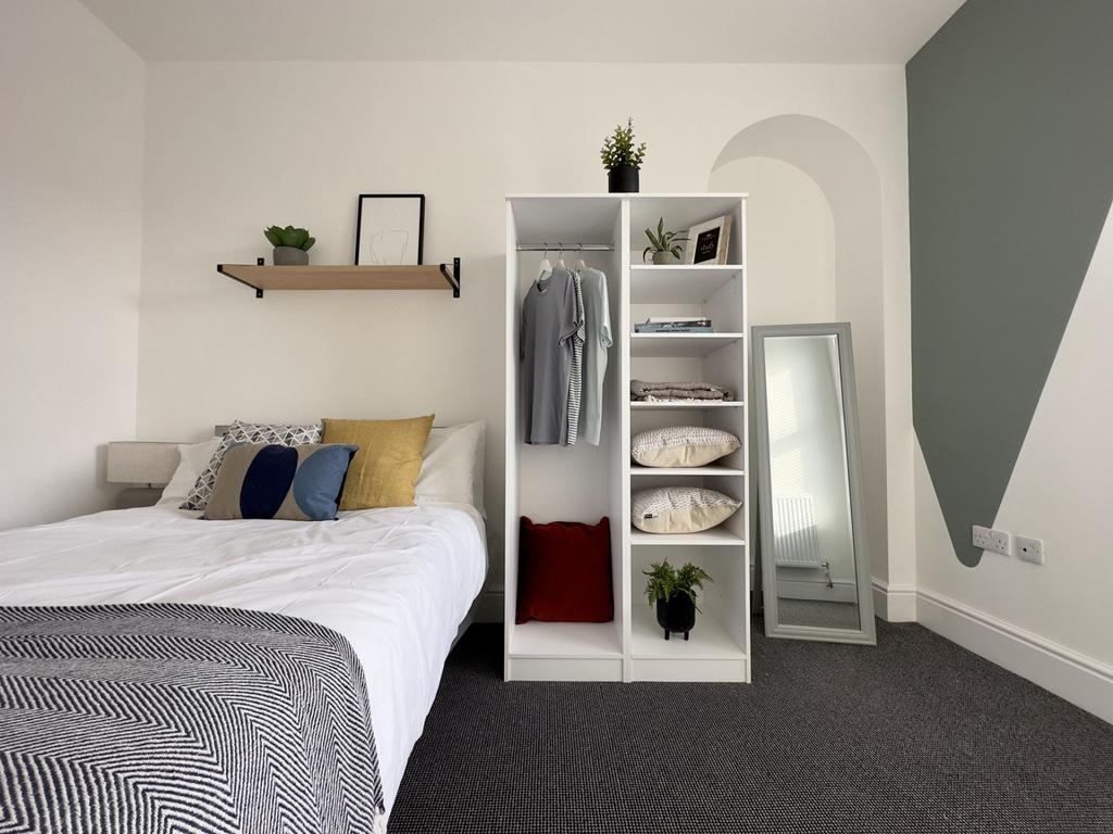 A bright and inviting double bedroom featuring ...