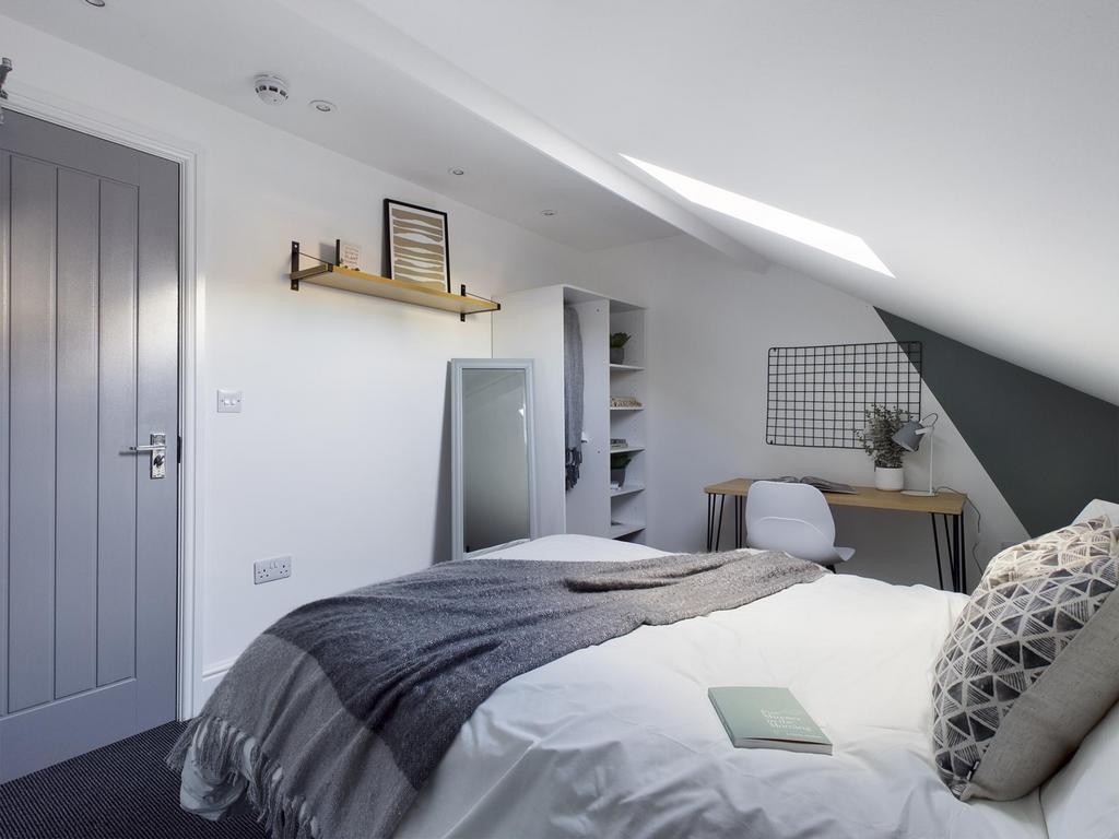 Bright, stylishly decorated double bedroom with...