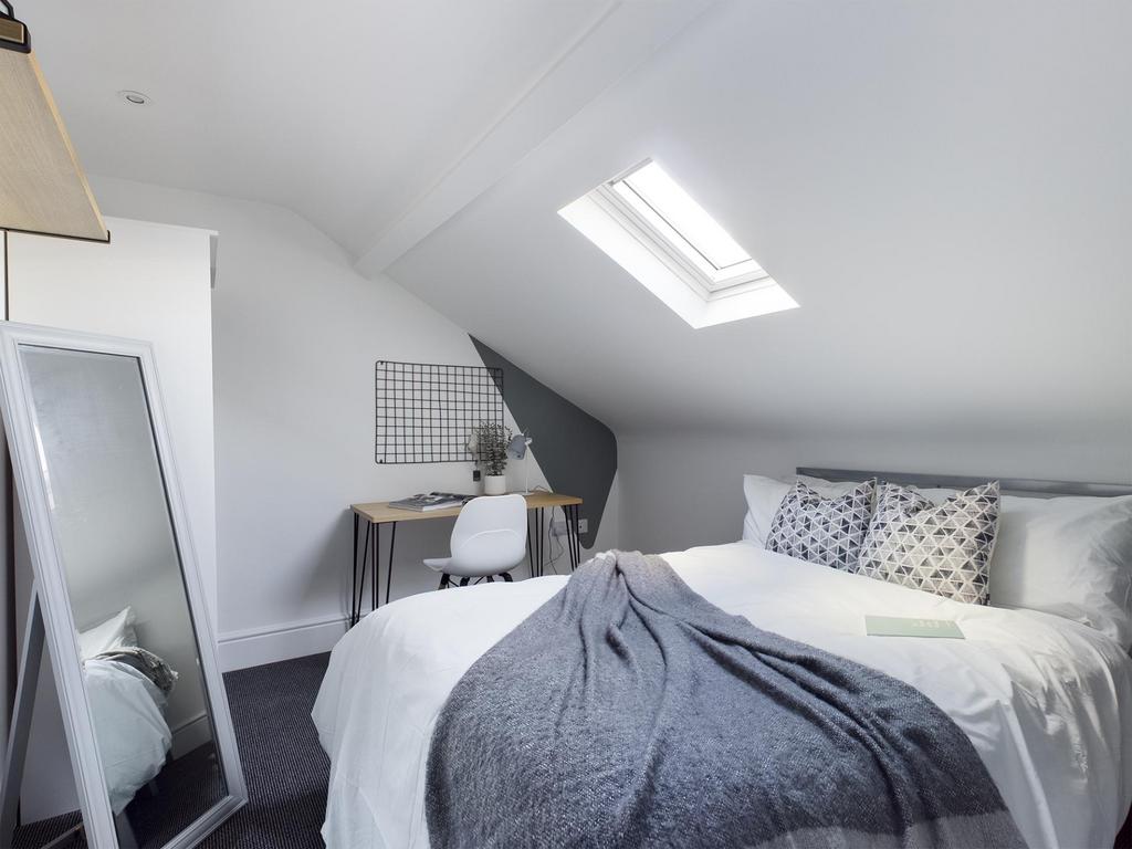 Bright, neatly styled attic double bedroom with...