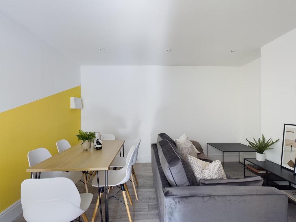 Bright, modern living area with a comfortable g...