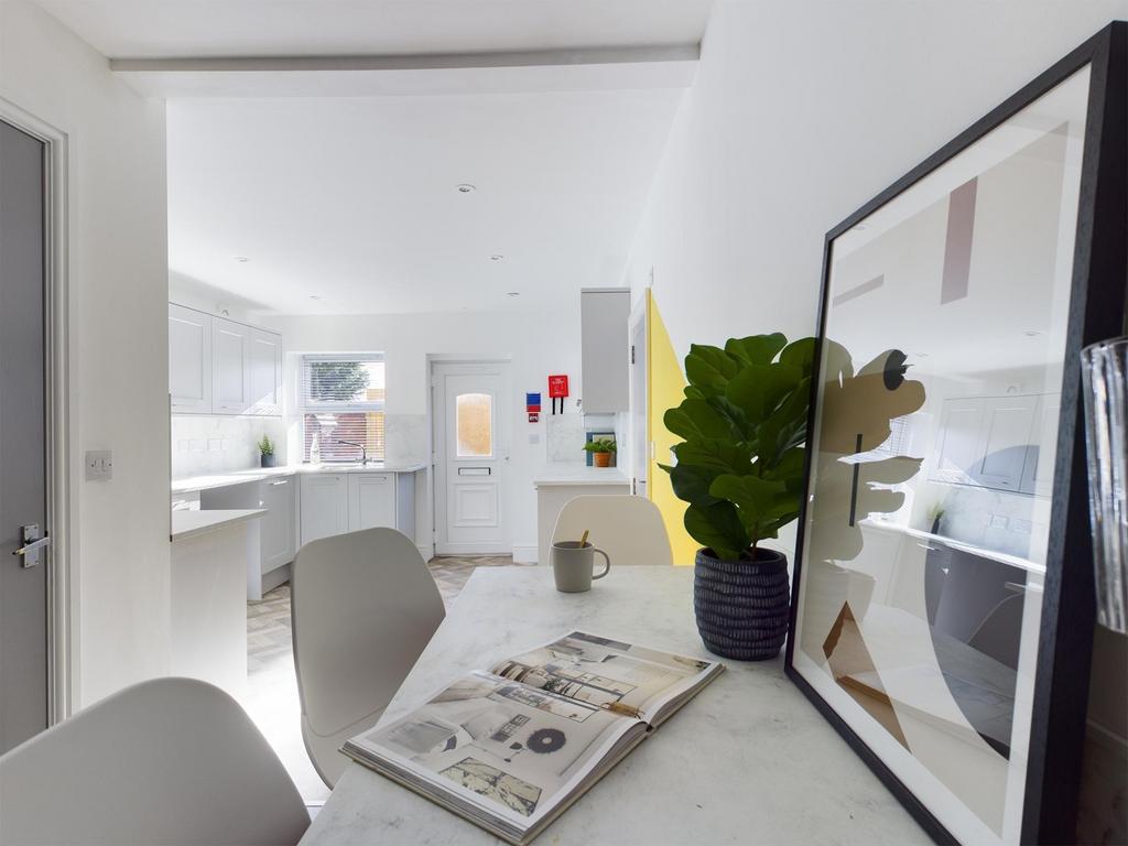Bright, modern kitchen-diner with a clean white...