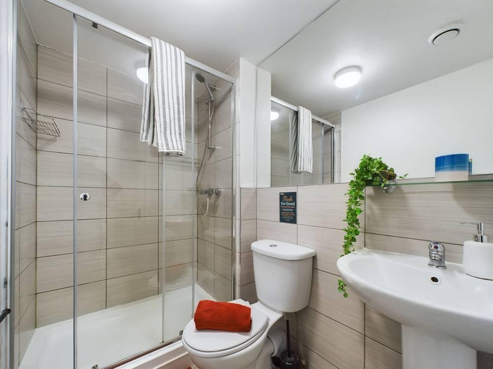 Bright, modern bathroom with a walk-in shower, ...
