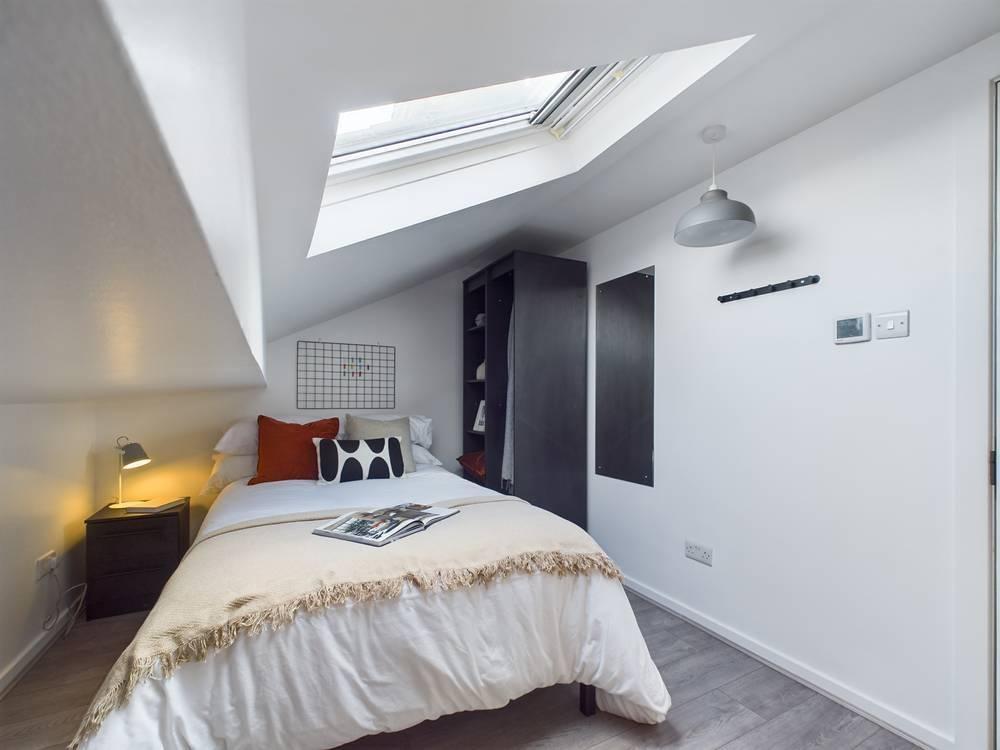 Bright, neatly presented bedroom with a comfort...