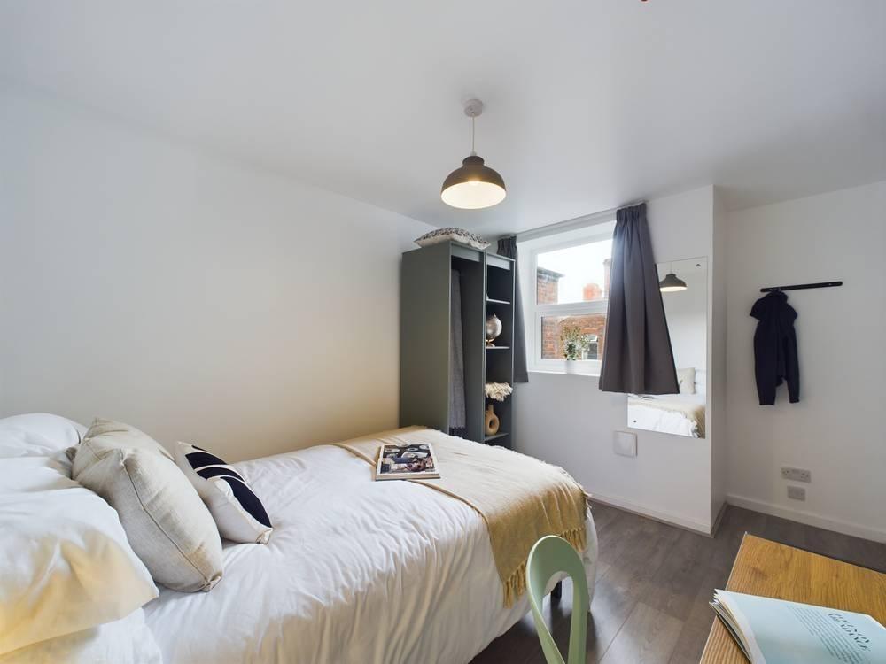 Bright, neatly presented bedroom with a comfort...