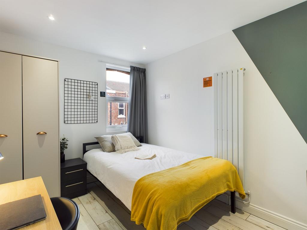 A bright and inviting double bedroom featuring ...