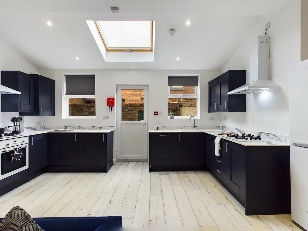 A modern and spacious kitchen with ample natura...