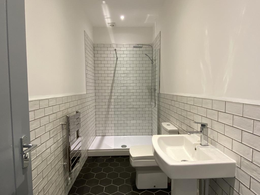 A modern and stylish bathroom featuring a spaci...