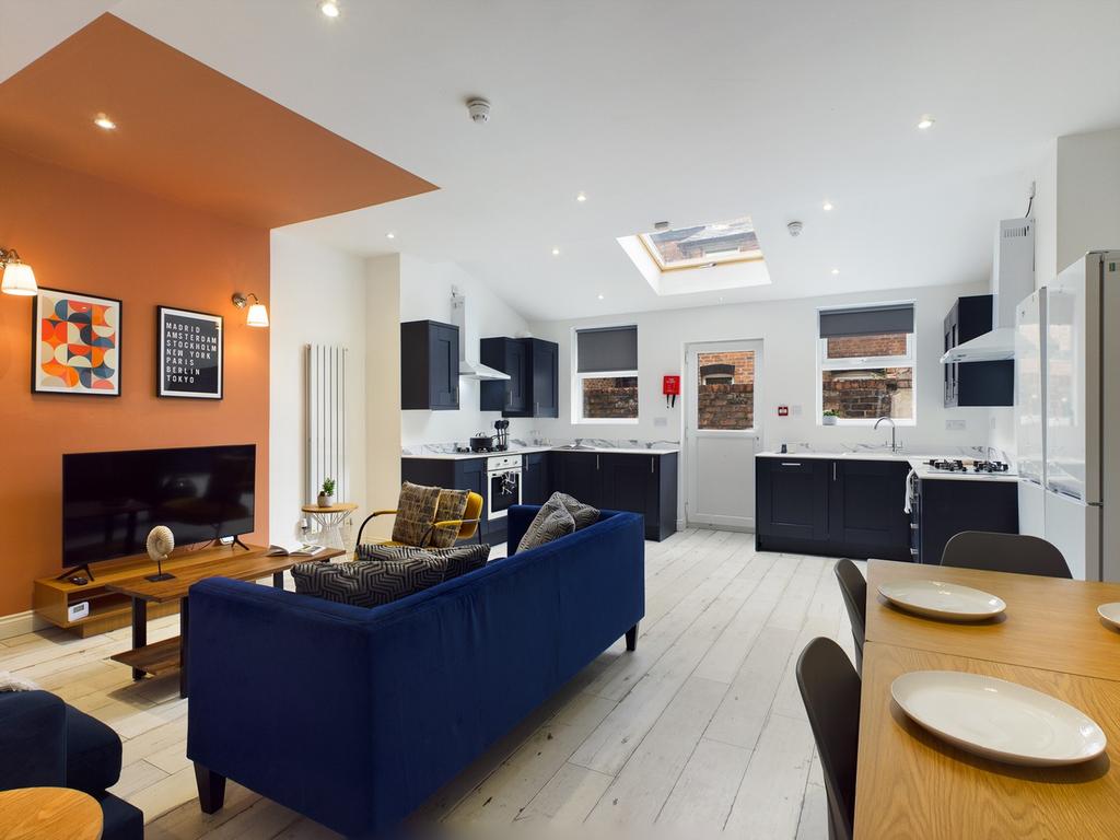 A spacious and modern kitchen area with ample n...