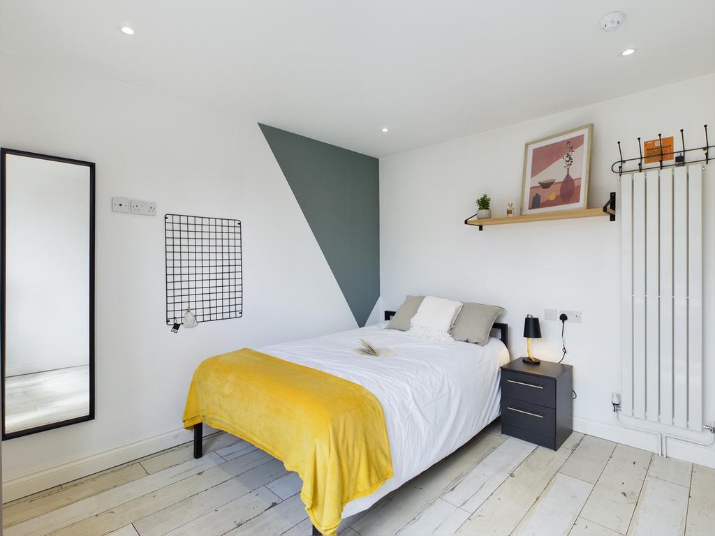 A bright and stylish double bedroom with modern...