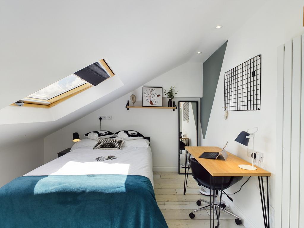 A bright and inviting double bedroom featuring ...