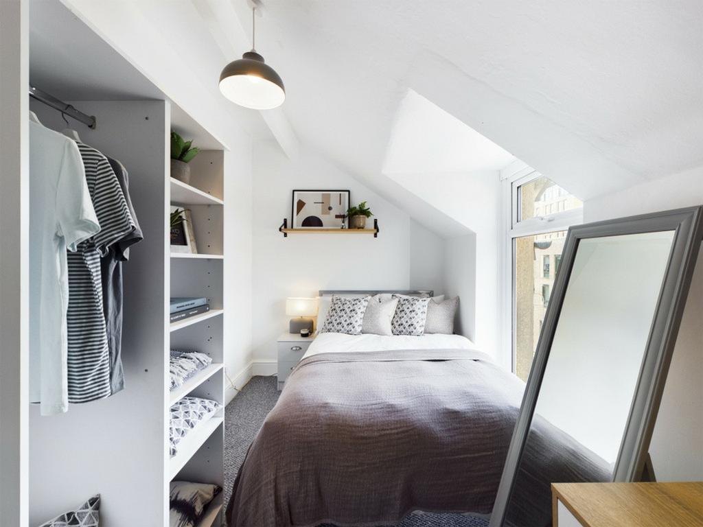 A bright and stylish double bedroom with ample ...