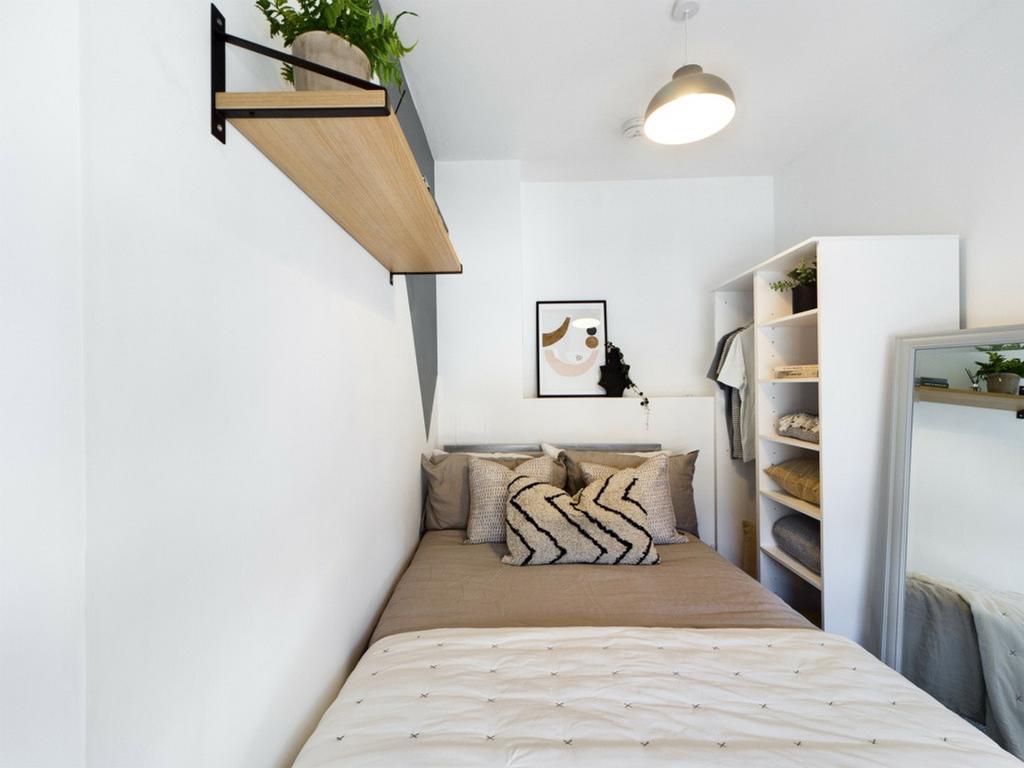 A stylish and well-organized double bedroom wit...