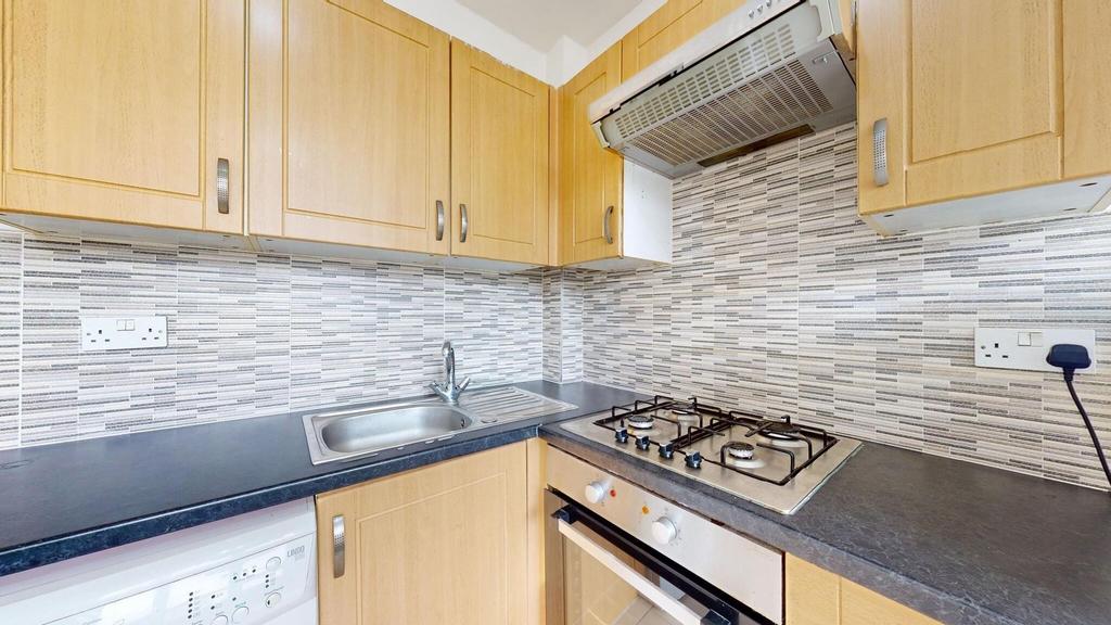 A well-maintained kitchen with wooden cabinets,...