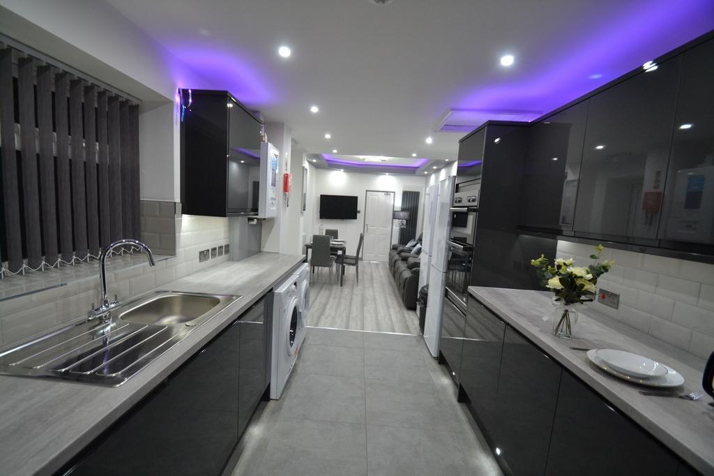 Modern, sleek kitchen with glossy black cabinet...
