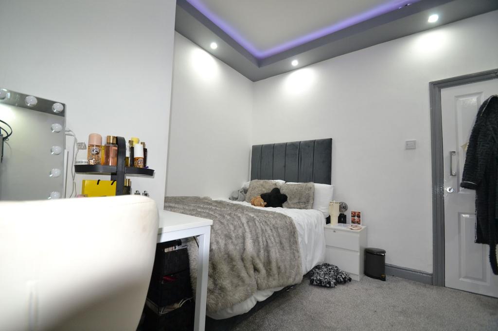 Bright, modern double bedroom with a plush grey...