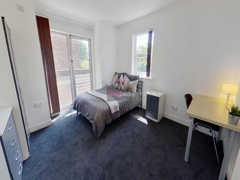 Bright, neatly presented bedroom with a comfort...