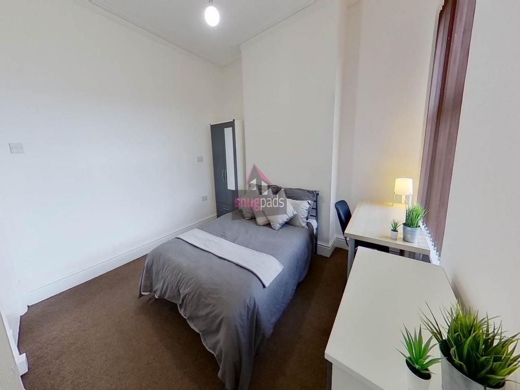 Bright, neatly presented bedroom with a double ...