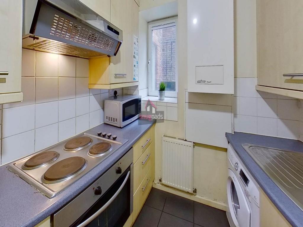 Compact fitted kitchen with electric hob, oven ...