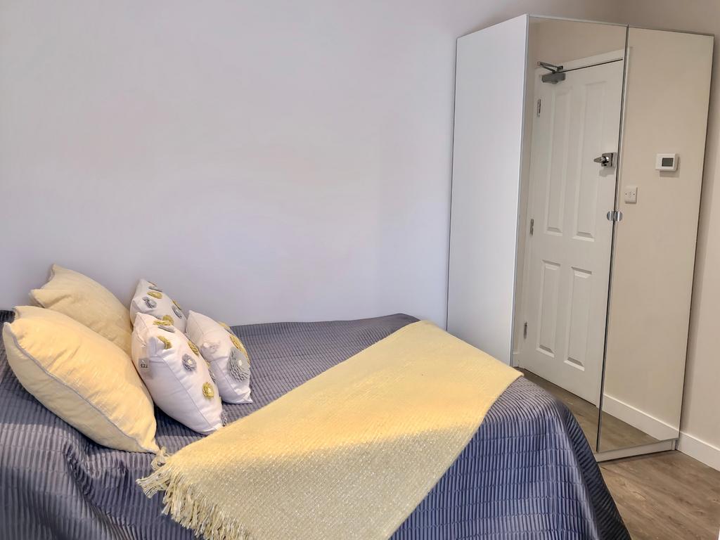 This inviting double bedroom features a cozy be...