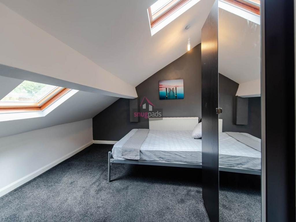 Bright, stylish attic double bedroom with slope...
