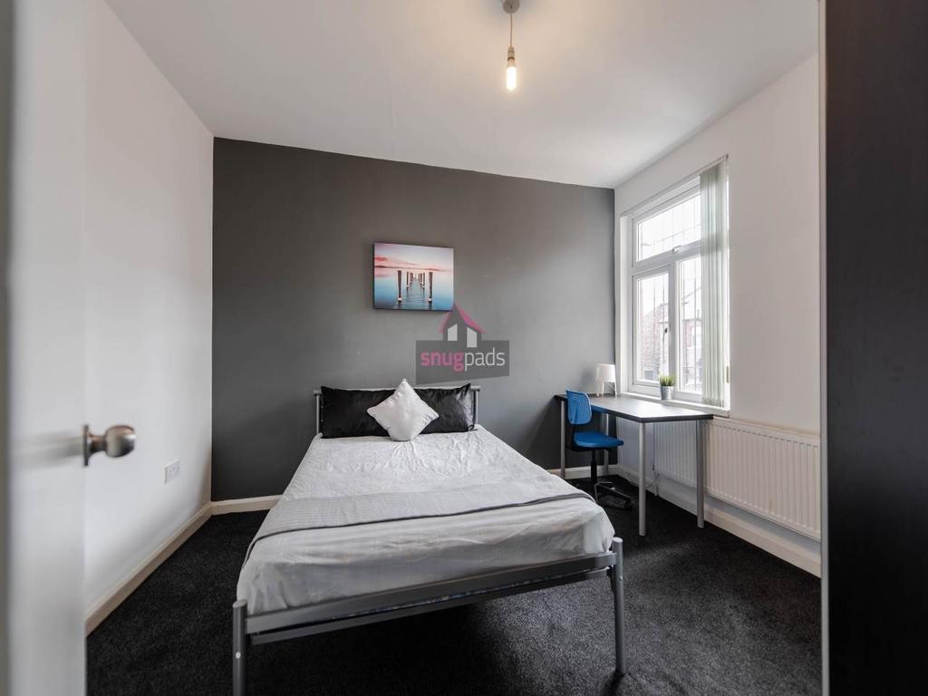 Bright, modern bedroom with a neutral feature w...