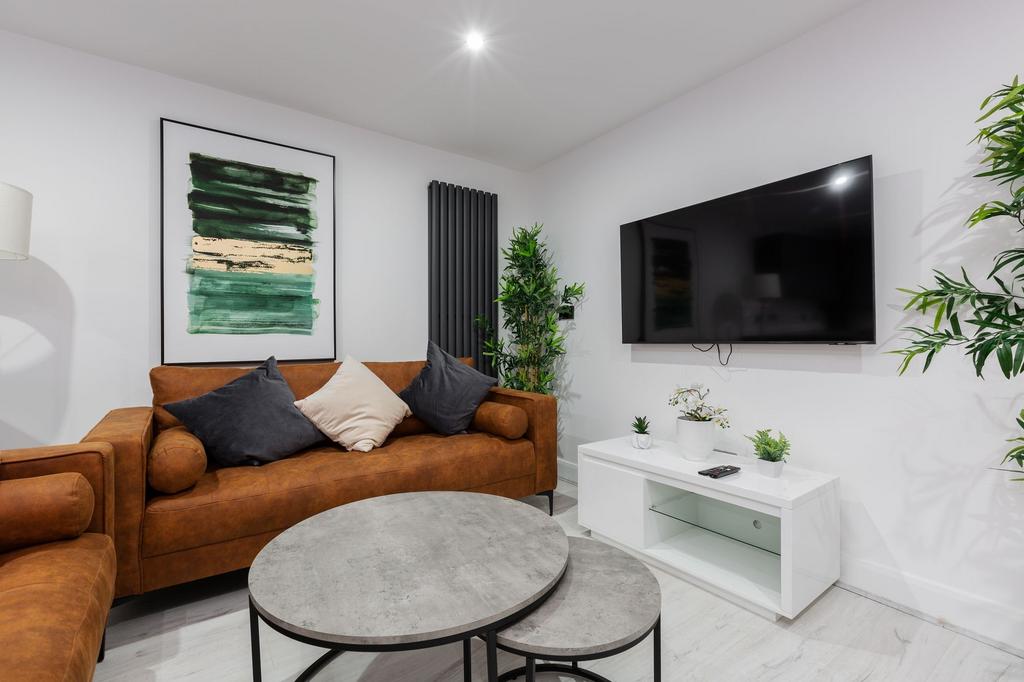A modern, bright living room featuring a comfor...
