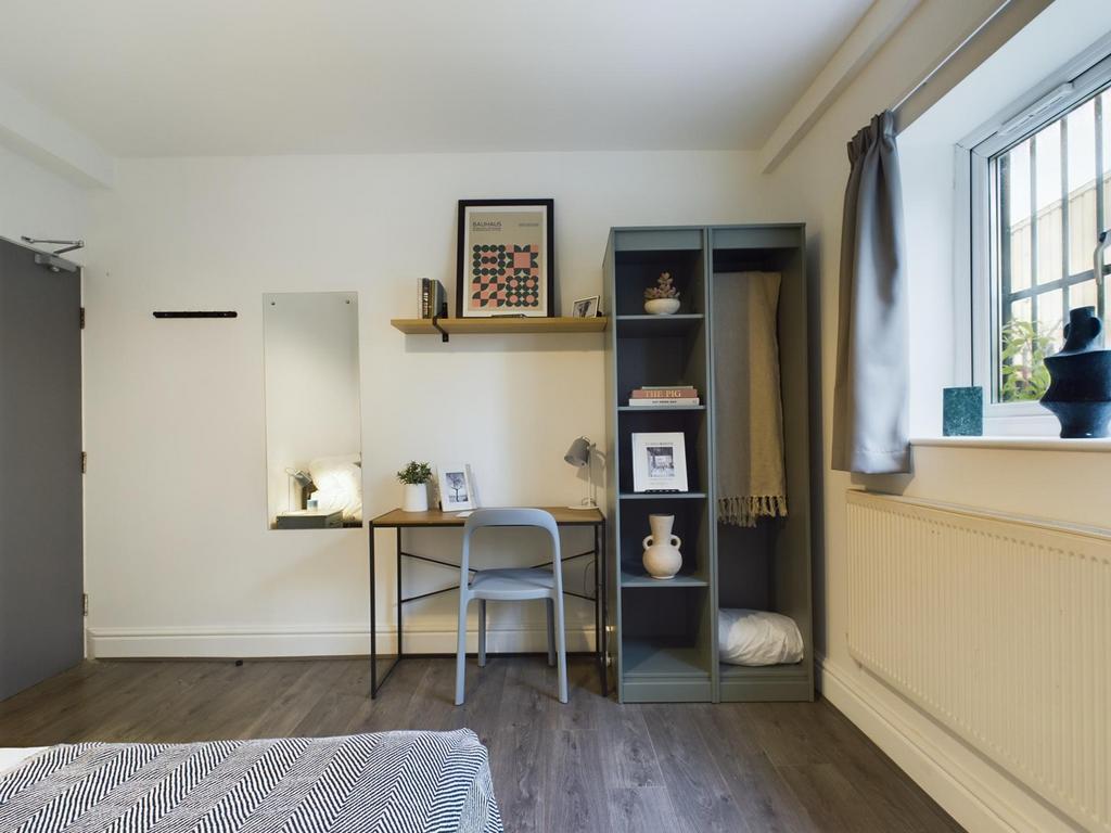 A bright and tidy double bedroom, featuring a s...