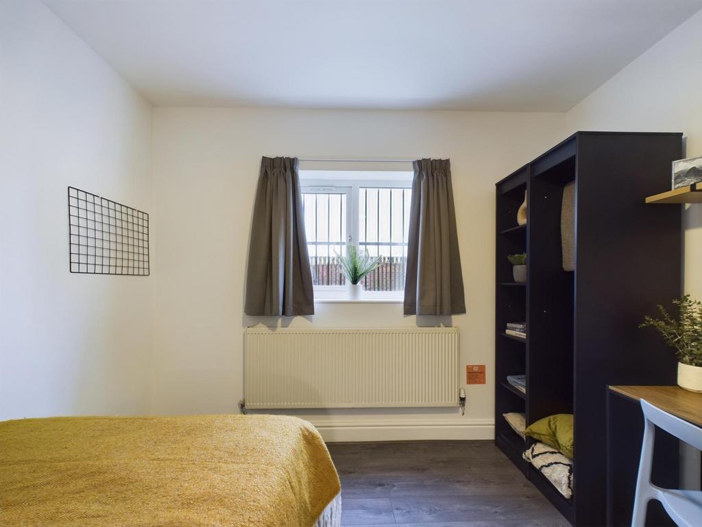 A bright and cozy double bedroom featuring a st...