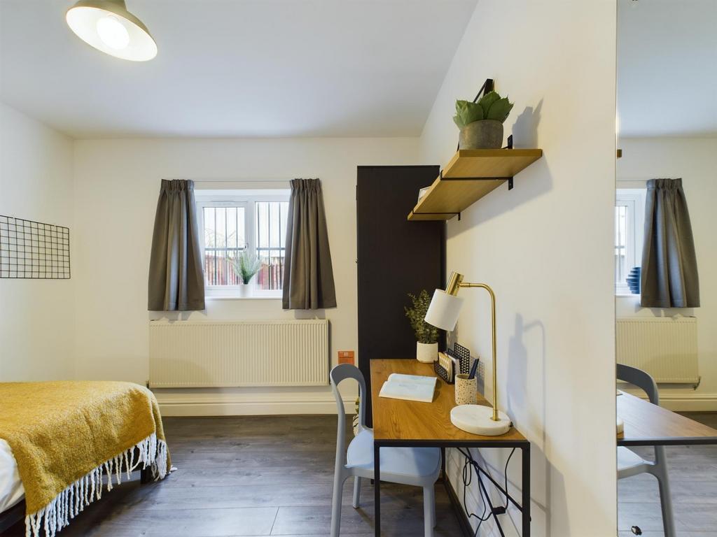 A bright and inviting double bedroom featuring ...